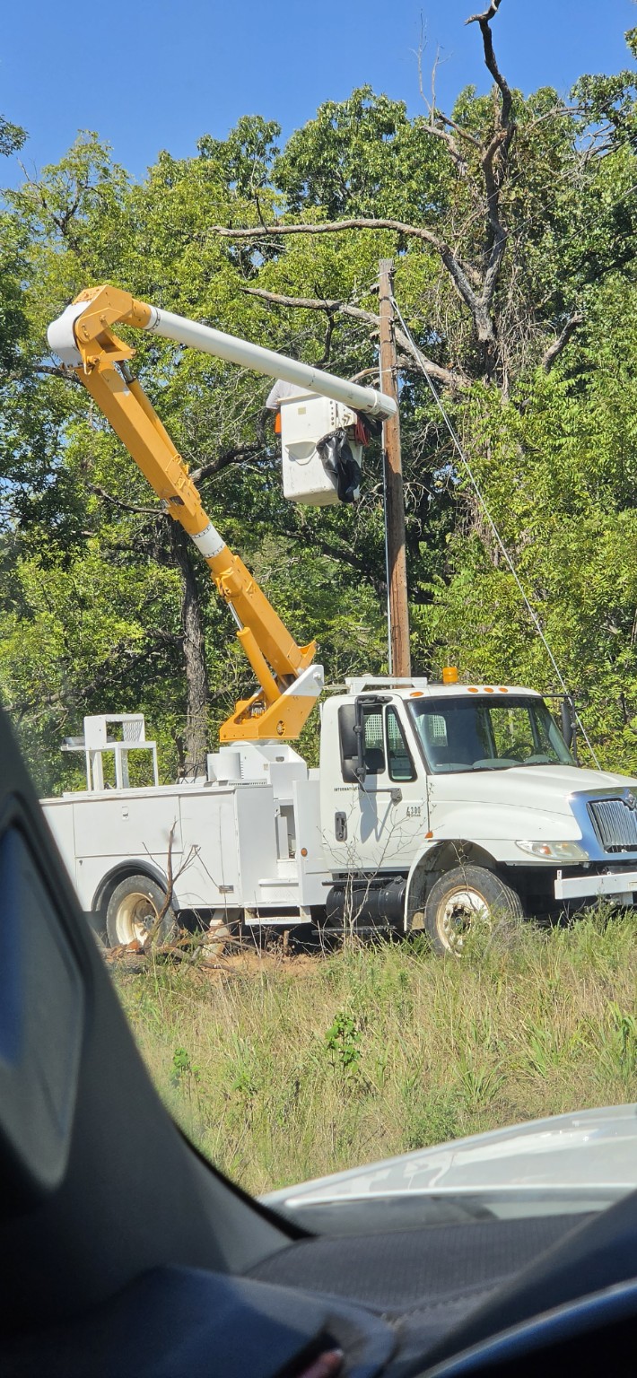 CMC bucket truck performing overhead electrical work